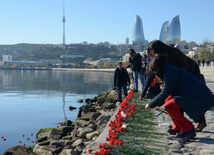 Baku residents bringing flowers to Seaside Boulevard to honor missing oil workers.  Azerbaijan, Dec.07, 2015